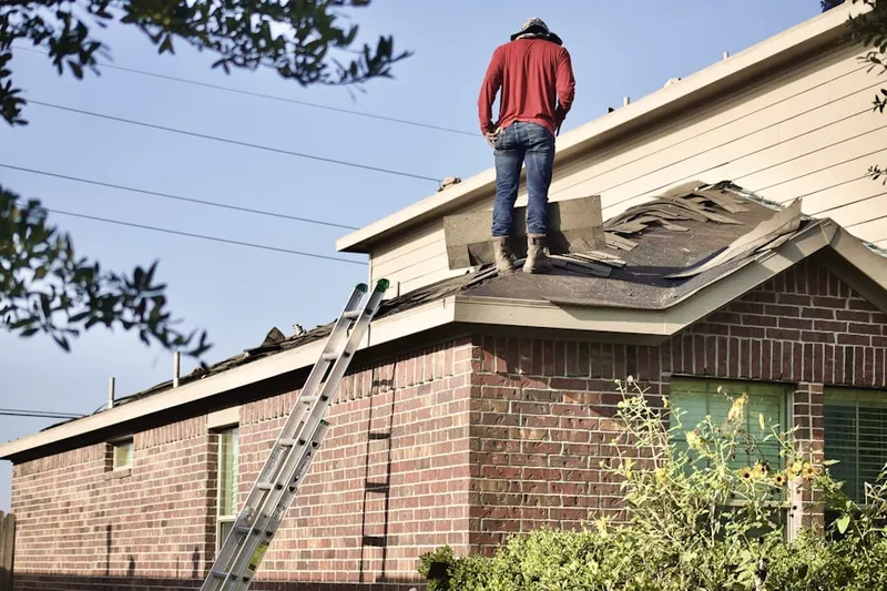 Professional roofer working on a residential roof in Schubert